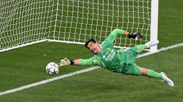 epa09982967 Goalkeeper Thibaut Courtois of Real Madrid saves the ball during the UEFA Champions League final between Liverpool FC and Real Madrid at Stade de France in Saint-Denis, near Paris, France, ...