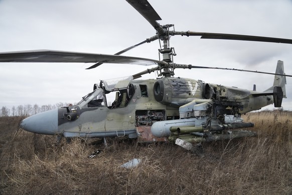 A Russian Ka-52 helicopter gunship is seen in the field after a forced landing outside Kyiv, Ukraine, Thursday, Feb. 24, 2022. Russia on Thursday unleashed a barrage of air and missile strikes on Ukra ...