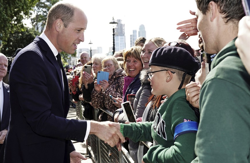 Britain&#039;s Prince William meets members of the public in the queue along the South Bank, near to Lambeth Bridge as they wait to view Queen Elizabeth II lying in state ahead of her funeral on Monda ...