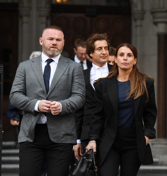 epa09938439 Coleen Rooney (R) departs the High Court with her husband and former England football captain Wayne Rooney (L) in London, Britain, 10 May 2022. Footballers&#039; wives Coleen Rooney and Re ...