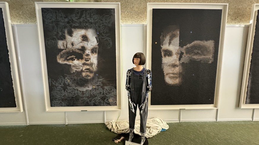 epa11709039 (FILE) - An undated handout photo made available by Sotheby&#039;s on 01 November 2024 shows the Ai-Da Robot in front of their AI created &#039;A.I. God. Portrait of Alan Turing&#039; artw ...
