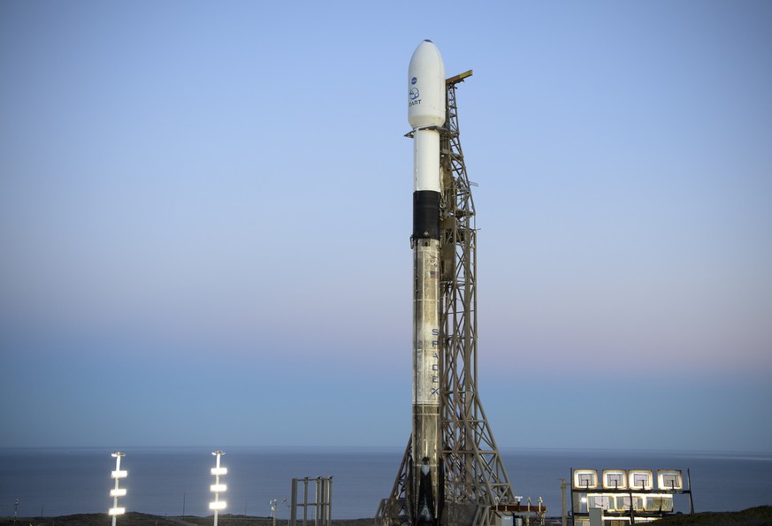 In this image provided by NASA, a SpaceX Falcon 9 rocket with the Double Asteroid Redirection Test, or DART, spacecraft onboard, sits during sunrise, Tuesday, Nov. 23, 2021, at Space Launch Complex 4E ...