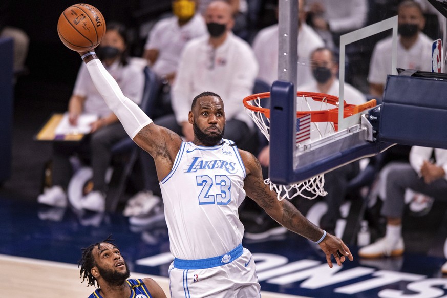 FILE- Los Angeles Lakers forward LeBron James (23) goes up high to dunk the ball during the first half of an NBA basketball game against the Indiana Pacers in Indianapolis, on May 15, 2021. James has  ...