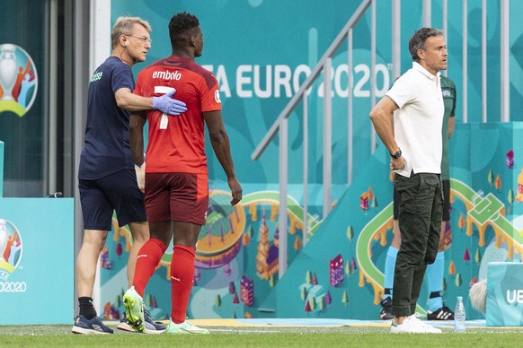 Switzerland&#039;s forward Breel Embolo, center, is led off the pitch injured next to Spain&#039;s head coach Luis Enrique, right, during the UEFA Euro 2020 soccer tournament quarterfinal soccer match ...