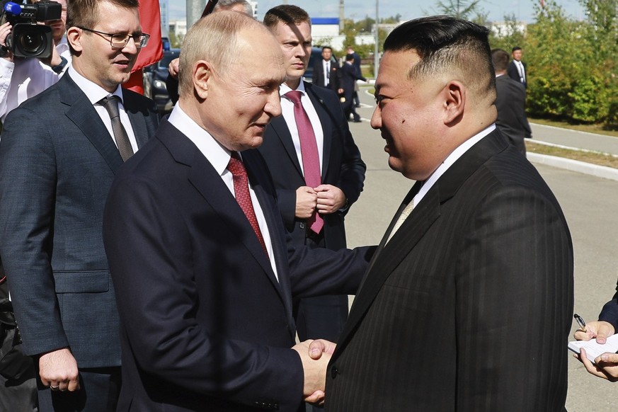 Russian President Vladimir Putin, left, and North Korea&#039;s leader Kim Jong Un shake hands during their meeting at the Vostochny cosmodrome outside the city of Tsiolkovsky, about 200 kilometers (12 ...