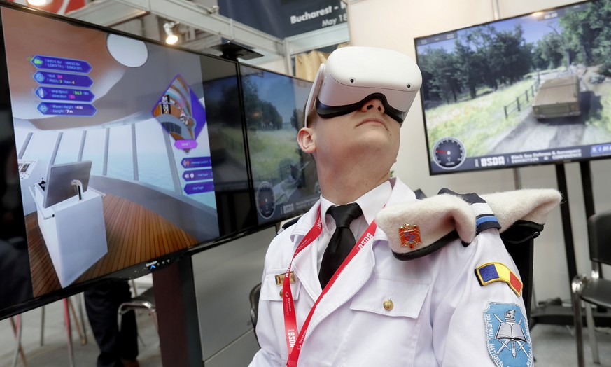 epa09955467 A Romanian military high-school cadet tests an augmented reality virtual training system designed by Romanian company SIMAVI during the first day of the Black Sea Defense &amp; Aerospace E ...