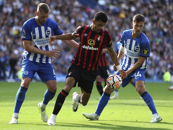Brighton and Hove Albion&#039;s Adam Webster, left, and Joel Veltman challenge Bournemouth&#039;s Dominic Solanke for the ball during the English Premier League soccer match between Brighton and Hove  ...