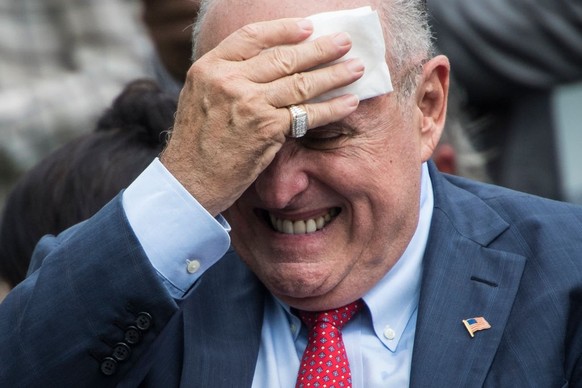 WASHINGTON, DC - MAY 30: Rudy Giuliani wipes his head before President Donald J. Trump arrives to speak at the White House Sports and Fitness Day event on the South Lawn of the White House on Wednesda ...
