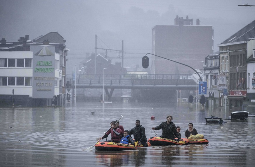 People use rubber rafts in floodwaters after the Meuse River broke its banks during heavy flooding in Liege, Belgium, Thursday, July 15, 2021. Heavy rainfall is causing flooding in several provinces i ...