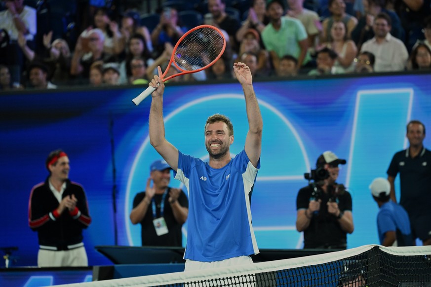 Australia's Jordan Smith holds his trophy aloft after defeating Joanna Garland of Taiwan to win the 1 Point Slam event ahead of the Australian Open in Melbourne, Australia, Wednesday, Jan. 14, 20 ...