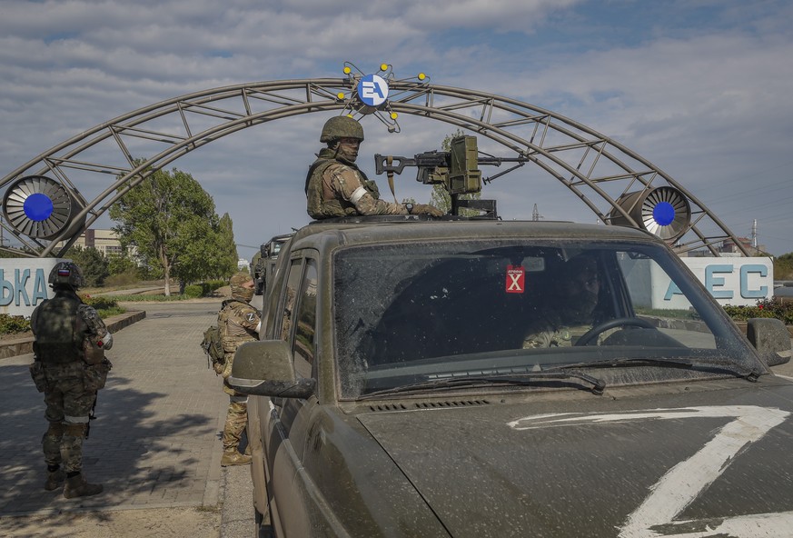 epa10134575 (FILE) A picture taken during a visit to Mariupol organized by the Russian military shows Russian serviceman on guard in front of the Zaporizhzhia Nuclear Power Station in Enerhodar, south ...