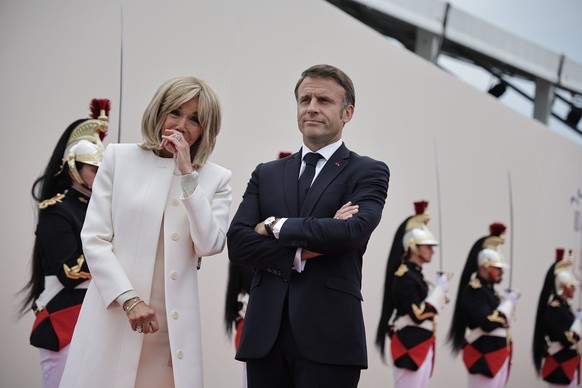 epa11393482 French President Emmanuel Macron (R), his wife Brigitte Macron attend a commemorative ceremony with dozens of heads of States and more than 200 veterans for the 80th anniversary of D-Day l ...