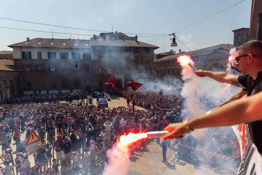 Soccer fans light flares on the square facing the St. Ambrogio church during the funeral service of former soccer great Franco Baresi, in Milan, Italy, Tuesday, Aug. 4, 2026. (Stefano Porta/LaPresse v ...