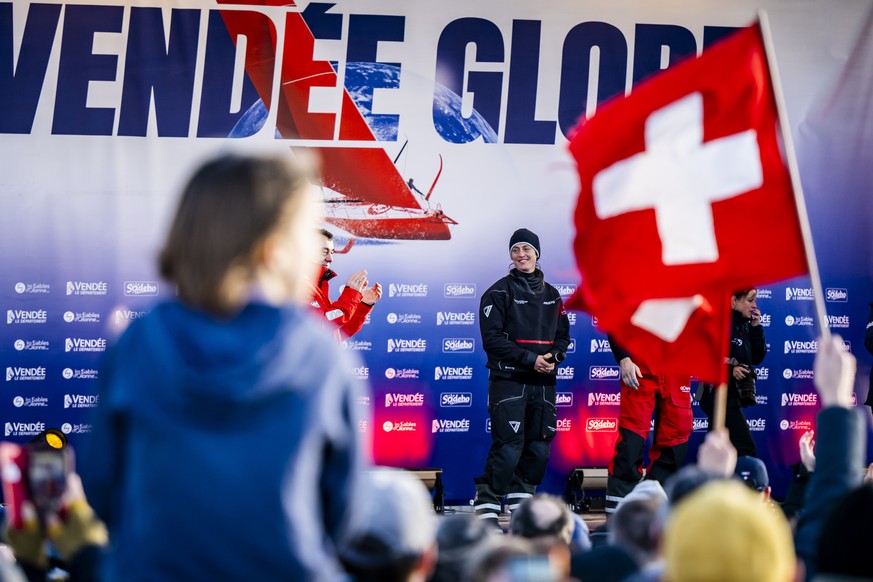 Skipper Justine Mettraux of Switzerland celebrates after crossing the finish line with her IMOCA Teamwork-Team Snef during the Vendee Globe round-the-world solo sailing race, in Les Sables-d&#039;Olon ...