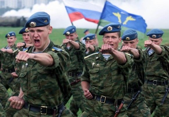 Russian paratroops officer cadets demonstrate hand-to-hand fighting, while Russian national and the combat arm flags fly in the background, during a show to mark the Airborne Forces 70th anniversary,  ...