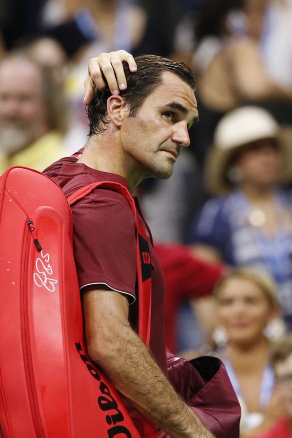 Roger Federer, of Switzerland, leaves the court after losing to John Millman, of Australia, during the fourth round of the U.S. Open tennis tournament early Tuesday, Sept. 4, 2018, in New York. (AP Ph ...