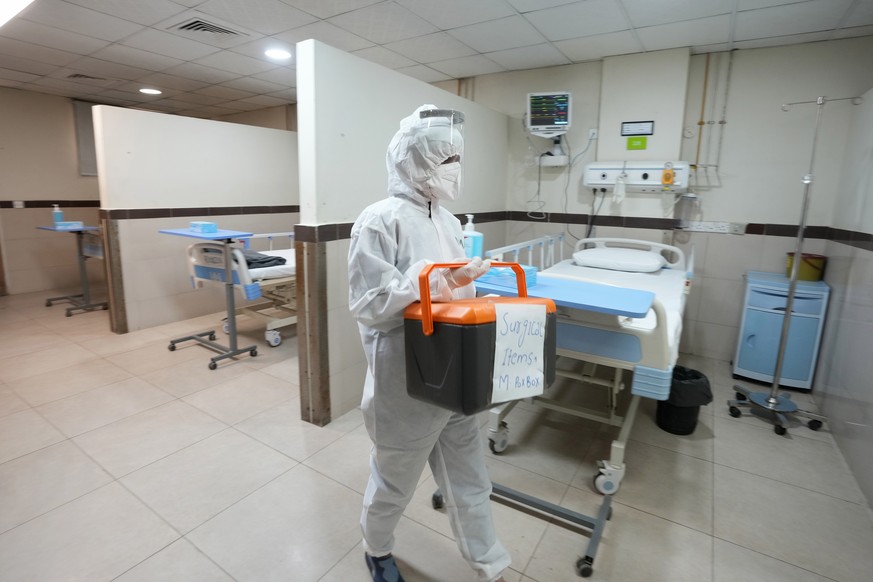 A paramedical staff member prepares an isolation ward set up as a preventative measure following Pakistan&#039;s health ministry confirmation of a case of mpox in the Khyber Pakhtunkhwa province, at a ...