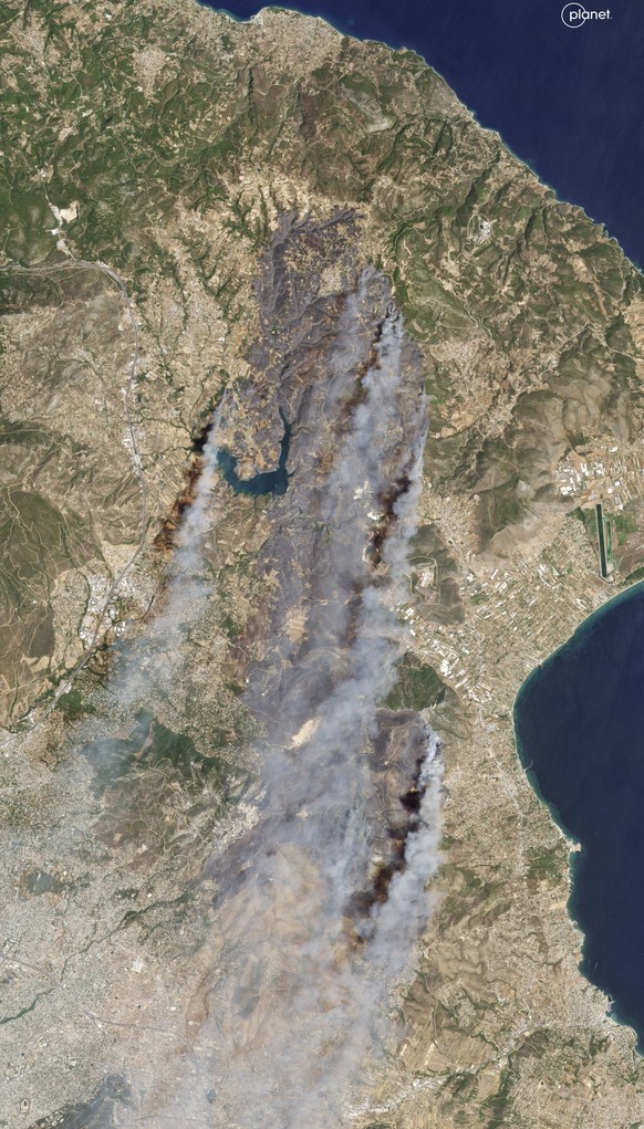 This satellite image shows smoke rising from wildfires in East Attica, some 35 kilometers (22 miles) north of Athens, which burned into the northern suburbs of Athens, triggering evacuations and leavi ...