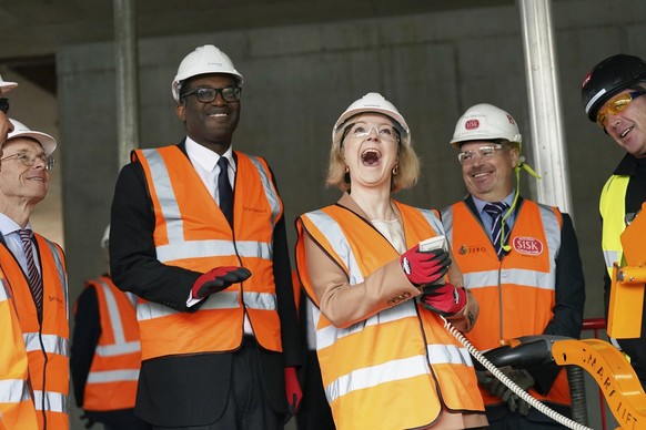 Britain&#039;s Prime Minister Liz Truss, centre right and Chancellor of the Exchequer Kwasi Kwarteng react during a visit to a construction site for a medical innovation campus, on day three of the Co ...