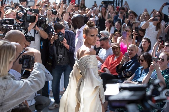 epa07690164 Canadian singer Celine Dion (C) poses for photographs as she attends the Alexandre Vauthier Fall/Winter 2019/20 Haute Couture collection show during the Paris Fashion Week, in Paris, Franc ...