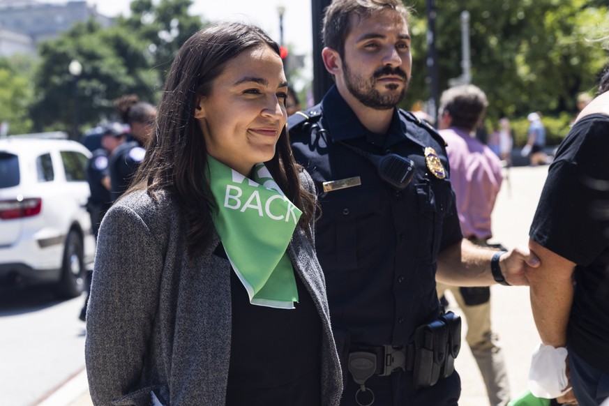 epa10080539 Democratic Congresswoman Alexandria Ocasio-Cortez is detained outside the Supreme Court while protesting its recent overturning of Roe v. Wade in Washington, DC, USA, 19 July 2022. Numerou ...