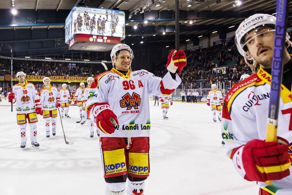 Biel&#039;s forward Luca Cunti #10, Biel&#039;s forward Tino Kessler #89 and Biel&#039;s forward Damien Brunner #96 celebrate their victory after defeating the team Geneve-Servette, during a National  ...