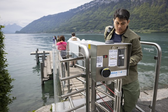 A Korean visitor leaves the pier after taking pictures in Iseltwald, Switzerland, Sunday, May 21, 2023. Lots of Asian TV fans and tourists visit the place because the romantic Korean Netflix drama &#0 ...