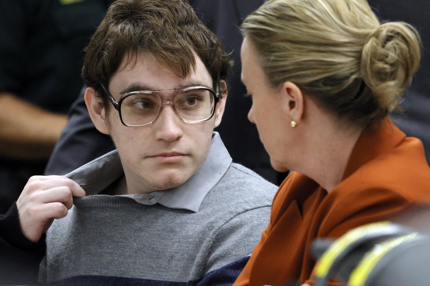 Marjory Stoneman Douglas High School shooter Nikolas Cruz tugs at his shirt collar as he is seated at the defense table for the verdict in his trial at the Broward County Courthouse in Fort Lauderdale ...