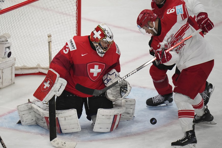 Switzerland&#039;s goalkeeper Leonardo Genoni saves during the semifinal match between Denmark and Switzerland at the ice hockey world championships in Stockholm,Sweden, Saturday, May 24, 2025. (AP Ph ...