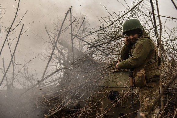 epa10569840 A Ukrainian artilleryman of the 57th Otaman Kost Hordiienko Separate Motorized Infantry Brigade as a 2s3 Akatsia howitzer fires at an undisclosed position near outskirts of Bakhmut, Donets ...