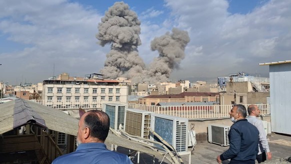 People watch as smoke rises on the skyline after an explosion in Tehran, Iran, Saturday, Feb. 28, 2026.(AP Photo)
Iran US Israel