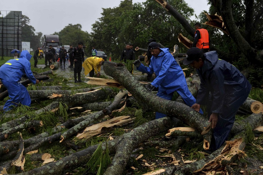 epa10048810 City Hall workers cut down a tree that fell on the South Pan-American highway, in Rivas, Nicaragua, 02 July 2022. Tropical storm Bonnie left the mainland of Nicaragua with no reported vict ...