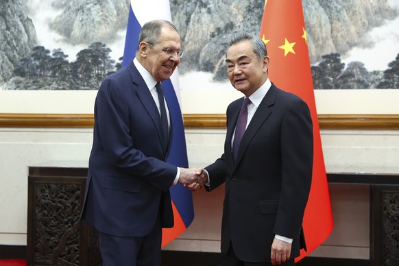 epa11267195 A handout photo made available by the Russian Foreign Ministry press service shows Russian Foreign Minister Sergey Lavrov (L) shaking hands with China&#039;s Foreign Minister Wang Yi durin ...
