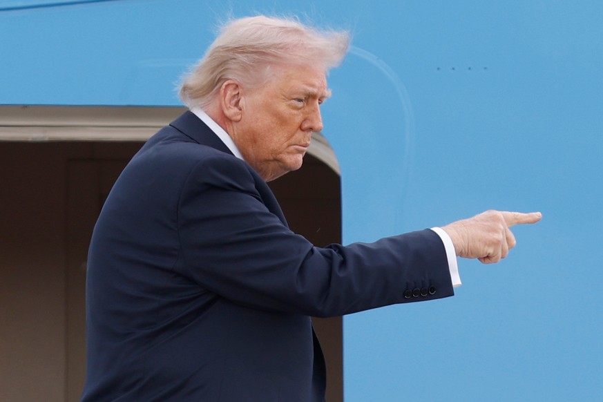 President Donald Trump gestures from the stairs of Air Force One at Joint Base Andrews, Md., Friday, April 24, 2026. (AP Photo/Luis M. Alvarez)
Trump