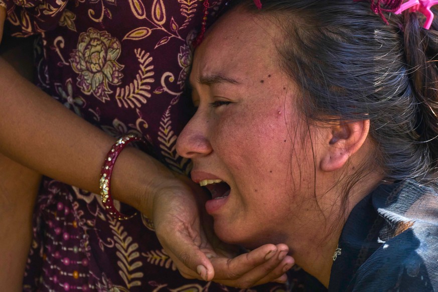 KEYPIX - A girl cries as she waits for news of relatives missing after flash floods in Bidur, Nepal's Nuwakot district, Thursday, Aug. 27, 2026. (AP Photo/Niranjan Shrestha)