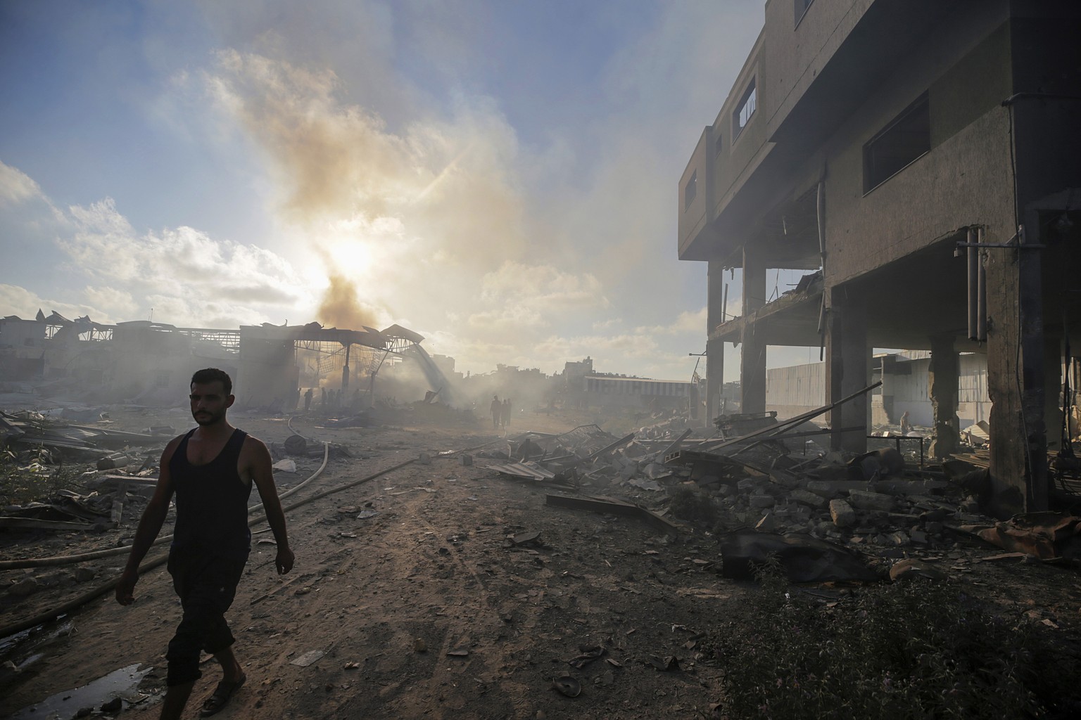 epa11488467 Palestinians inspect the rubble of a destroyed building following an Israeli air strike in the Al-Zawaida neighborhood, central Gaza Strip, 19 July 2024. More than 38,000 Palestinians and  ...