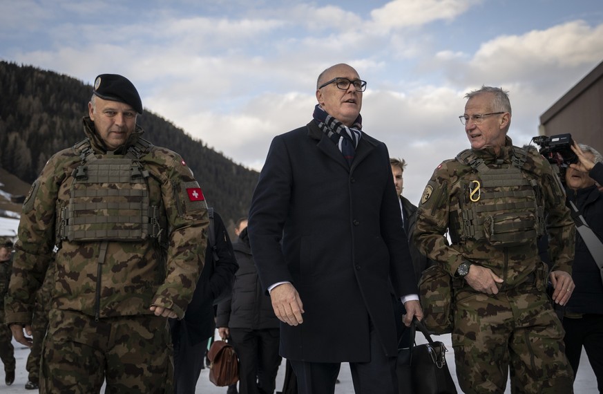 Switzerland's Minister for Defence, Civil Protection and Sport Martin Pfister, center, and Benedikt Roos, Chief of the armed forces, left, with Division Commander Maurizio Dattrino, right, pictur ...