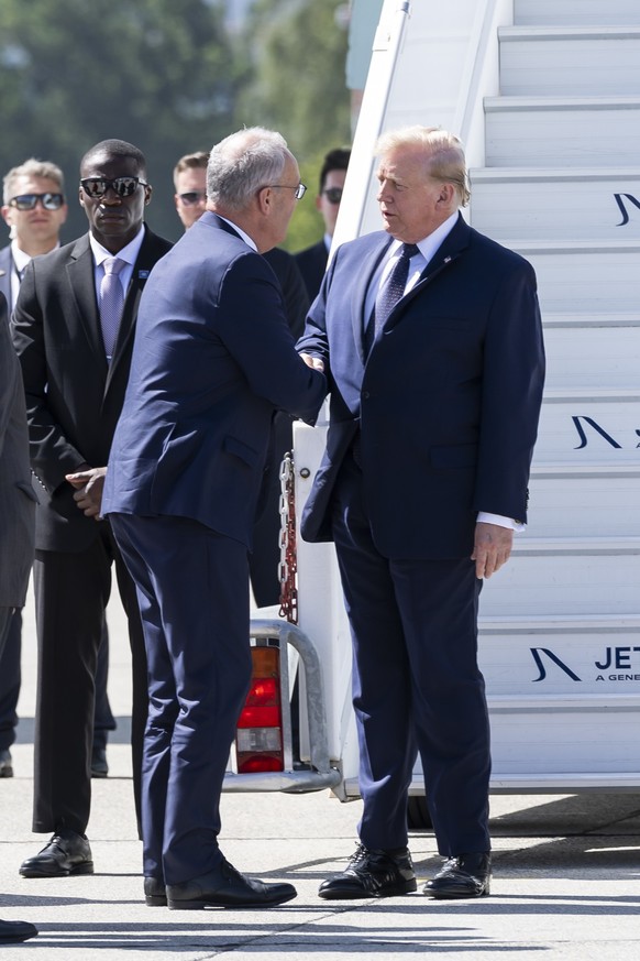 Swiss Federal President Guy Parmelin, left, welcomes US President Donald Trump, right, after Trump disembarked from Air Force One at Geneva Airport prior the G7 summit in nearby Evian (France), in Gen ...