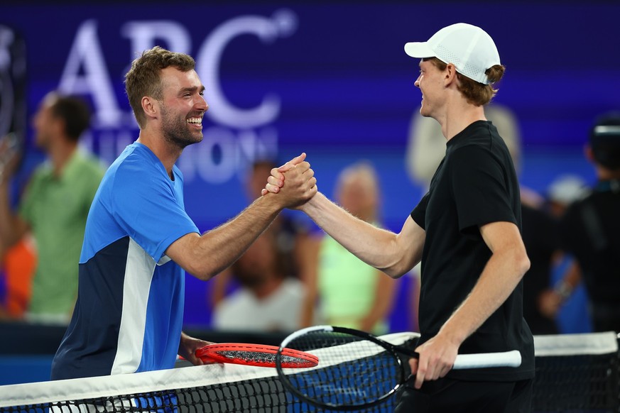 MELBOURNE, AUSTRALIA - JANUARY 14: Jordan Smith embraces Jannik Sinner of Italy during the 1 Point Slam ahead of the 2026 Australian Open at Melbourne Park on January 14, 2026 in Melbourne, Australia. ...