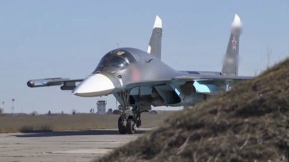 epa09898364 A handout still image taken from a handout video made available by the Russian Defence Ministry&#039;s press-service shows a Russian fighter-bombers Su-34 preparing to take off to carry ou ...