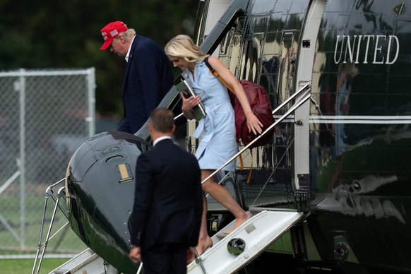 President Donald Trump and executive assistant Natalie Harp step off from Marine One upon they arrival at the Ellipse just outside of the White House, Sunday, Aug. 16, 2026, in Washington. (AP Photo/J ...