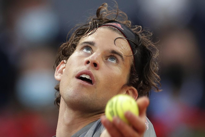 Dominic Thiem of Austria prepares to serve to Marcos Giron of the U.S. during their match at the Madrid Open tennis tournament in Madrid, Spain, Tuesday, May 4, 2021. (AP Photo/Paul White)