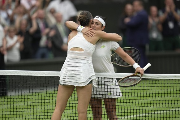 Tunisia&#039;s Ons Jabeur, right, embraces Aryna Sabalenka of Belarus after beating her in their women&#039;s semifinal singles match on day eleven of the Wimbledon tennis championships in London, Thu ...