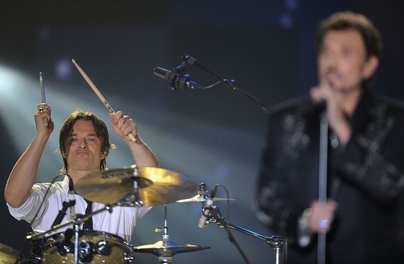 PARIS - FEBRUARY 28: Singer Johnny Hallyday and son drummer David Halliday (L) perform on stage during the &#039;Les Victoires de la Musique&#039; at the Le Zenith on February 28, 2009 in Paris, Franc ...