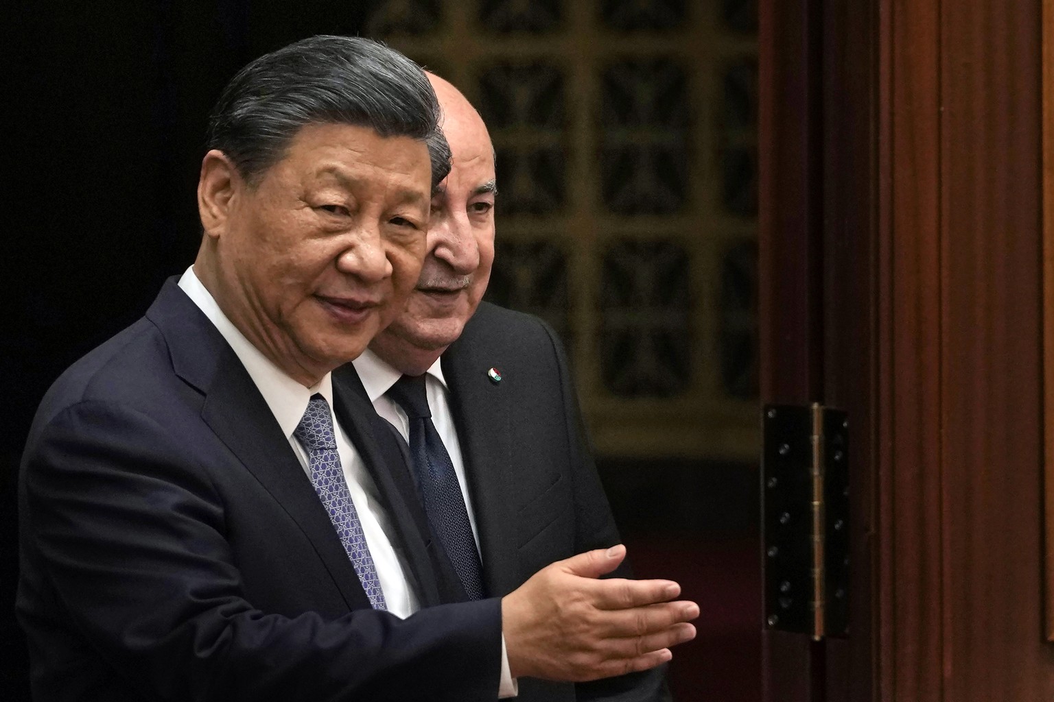 epa10753056 Chinese President Xi Jinping (L) shows the way for Algerian President Abdelmadjid Tebboune as they arrive for a signing ceremony held at the Great Hall of the People in Beijing, China, 18  ...