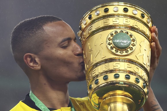 Dortmund's Manuel Akanji celebrates with the tropy after the German soccer cup (DFB Pokal) final match between RB Leipzig and Borussia Dortmund in Berlin, Germany, Thursday, May 13, 2021. Dortmun ...