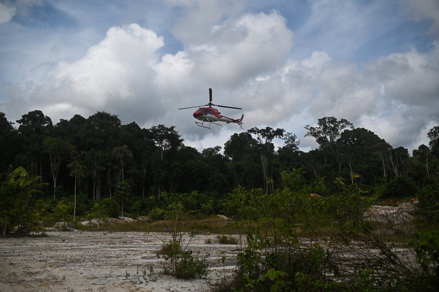 epa10469294 A helicopter lands in an area hit by illegal mining in the Altamira Environmental Forest, during an operation by the Brazilian authorities against deforestation and illegal mining, near It ...