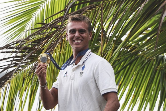 epa11529234 Gold medalist Kauli Vaast of France pose for photographs after the Men Finals of the Surfing competitions in the Paris 2024 Olympic Games, in Teahupo&#039;o, Tahiti, 05 August 2024. EPA/FA ...