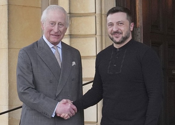 Britain&#039;s King Charles III and Ukrainian President Volodymyr Zelenskyy, right, shake hands during their meeting at the Sandringham Estate in Norfolk, England, Sunday, March 2, 2025. (Joe Giddens/ ...