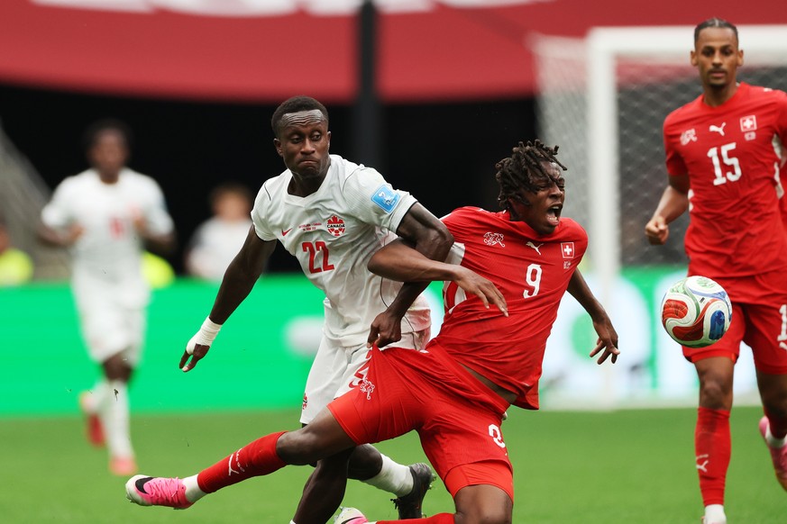Switzerland's Johan Manzambi (9) cries out as he collides with Canada's Richie Laryea (22) during the World Cup Group B soccer match between Switzerland and Canada in Vancouver, British Colu ...